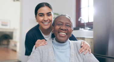 caregiver and elder woman smiling