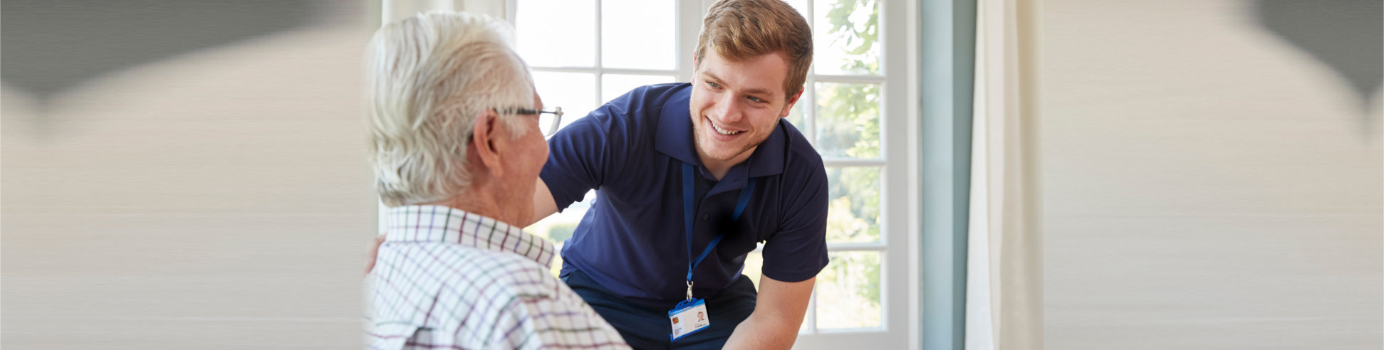 medical staff assisting elder man